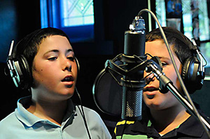 Yehuda and Yisroel Braun (twin sons of Chazan Braun) in the recording studio.